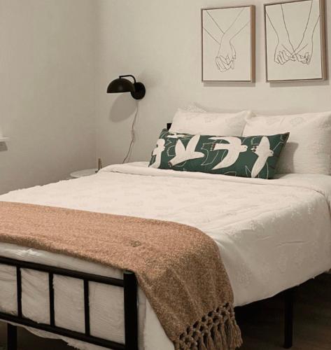 a bedroom with a bed with white sheets and pillows at Private double Delight Couple Room in Abu Dhabi