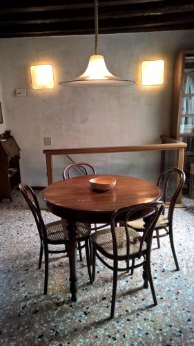 a wooden table and chairs in a room with a light at DoMarie in Venice