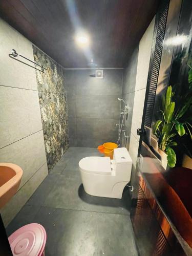 a bathroom with a bath tub and a toilet at MarariBeachLaVista1 in Alleppey