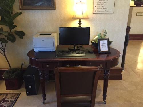 a desk with a computer and a keyboard on it at Bay Landing Hotel in Burlingame