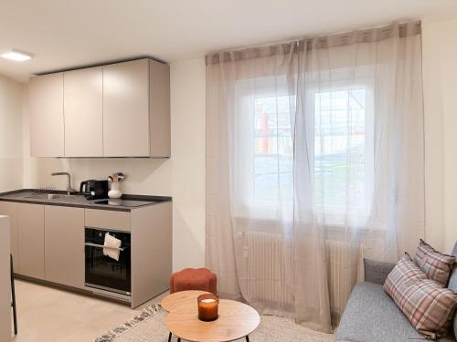 a living room with a couch and a window at Studio in central Crans-Montana in Crans-Montana