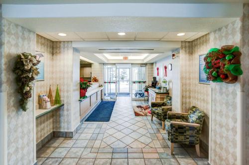 a lobby with a hallway with chairs and a counter at Motel 6-Red Deer, AB in Red Deer