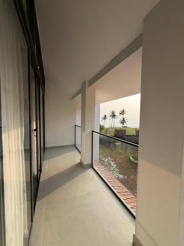 a hallway of a building with a view of the water at Shoonya - A Boutique Stay in Varkala