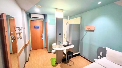 a small bathroom with a sink and a shower at Ibis Budget Jakarta Airport in Tangerang