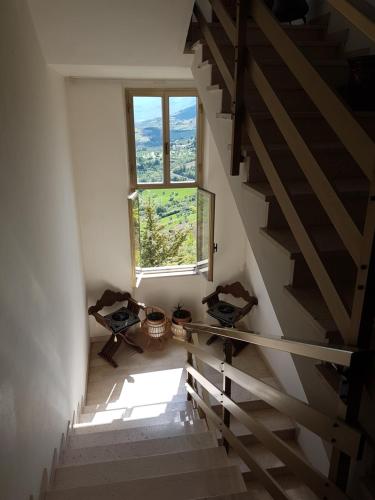 an attic stairway with a window and a stair case at Clementina B&B in Brittoli