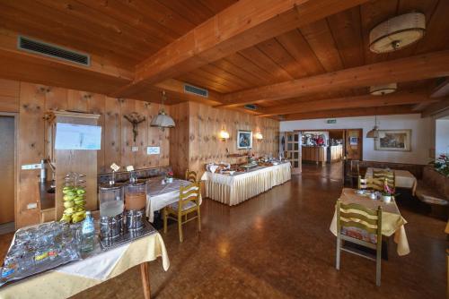 a large room with tables and chairs in a building at Steinegger Eppan in Appiano sulla Strada del Vino