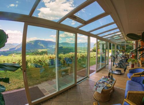 a conservatory with a view of the mountains at Steinegger Eppan in Appiano sulla Strada del Vino
