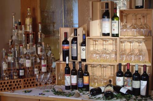 a display of wine bottles and glasses on a table at Gasthof Hotel Terzer in Cortaccia