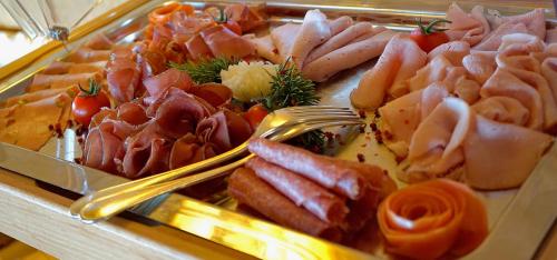 a tray filled with different types of meats and vegetables at Steinegger Eppan in Appiano sulla Strada del Vino