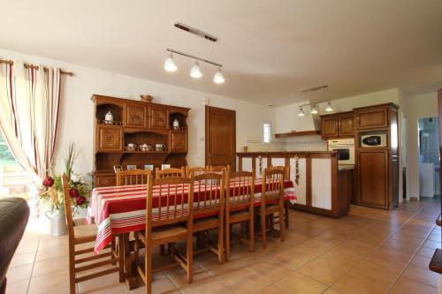 una cucina e una sala da pranzo con tavolo e sedie di Errotalde-berria a Sare