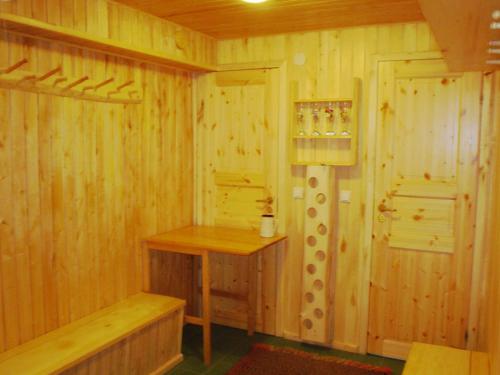 a wooden room with a bench and a door at Udumäe Holiday Farm in Kirikuküla