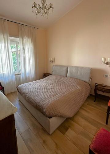 een slaapkamer met een bed en een kroonluchter bij Dimora Sulle Mura in Anagni