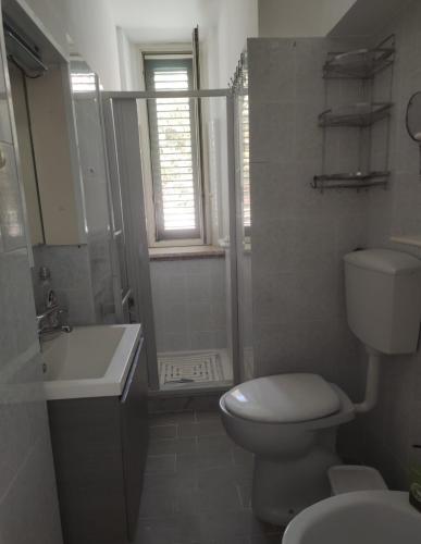 a bathroom with a toilet and a sink and a shower at Casa del Ferroviere in Letojanni