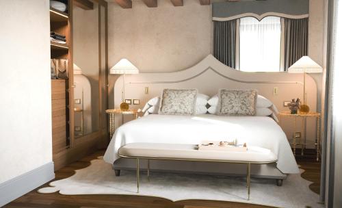 a bedroom with a large bed with a white bed frame at Gabrielli Luxury Apartments Venezia - Starhotels Collezione in Venice