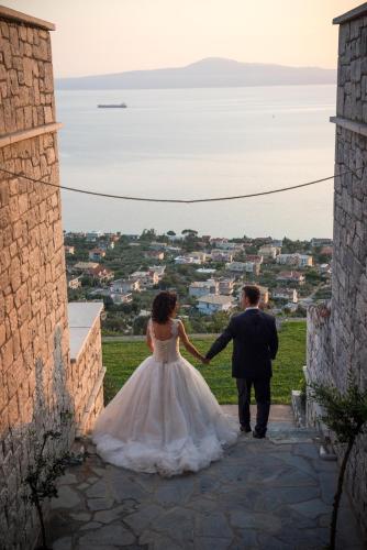 a bride and groom walking up the steps of a building at Petra Thea in Kalamata