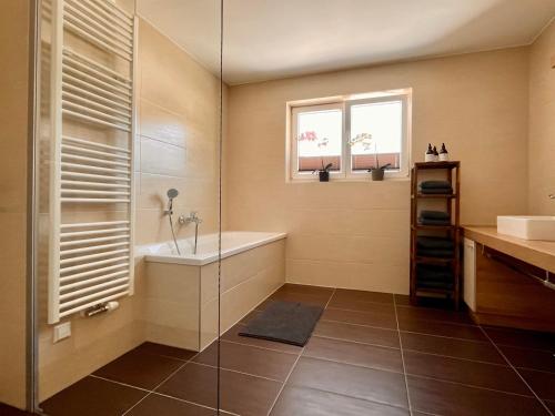 a bathroom with a shower and a tub and a sink at Ramsaublick in Ramsau am Dachstein