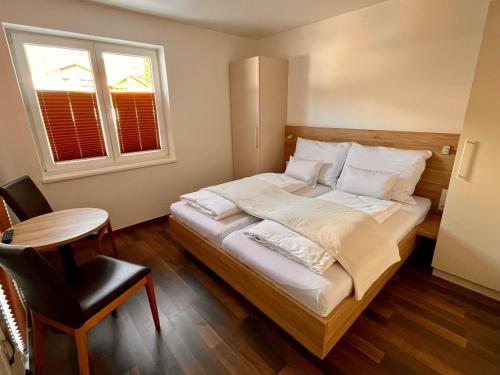 a bedroom with a large bed and a window at Ramsaublick in Ramsau am Dachstein