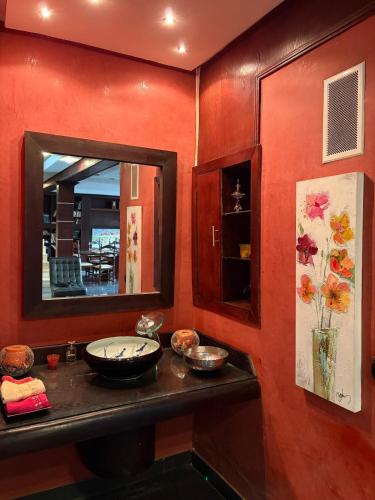 a bathroom with a mirror and a counter with a sink at Welcome to your Stylish apartment in Oulad Akkou