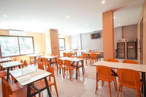 a dining room with tables and chairs in a restaurant at VELIN Pattaya Hotel in Pattaya Central