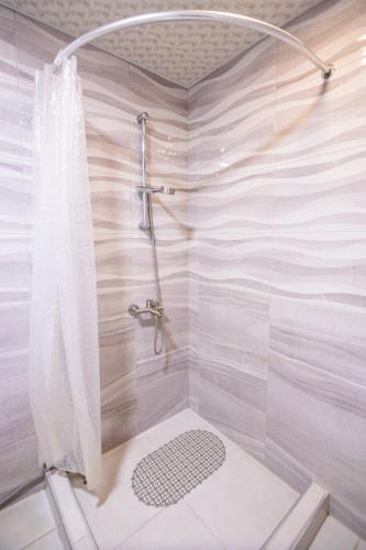 un bagno con doccia con tenda da doccia di MBM Hotel a Yerevan