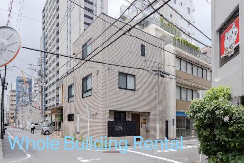 a building on the side of a city street at Clover House in Tokyo