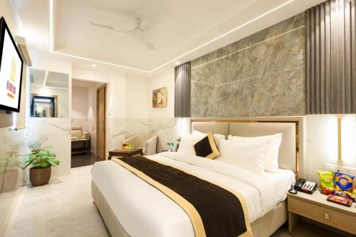a bedroom with a large bed in a room at Hotel Era Premium Near Delhi Airport in New Delhi