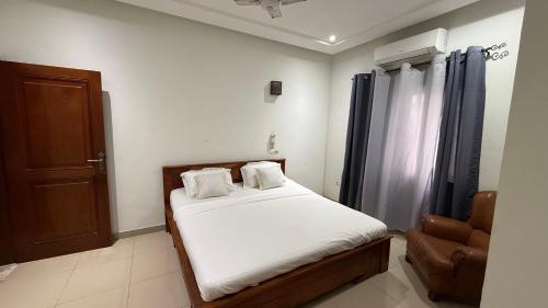 En eller flere senge i et værelse på La Maison des Palmiers