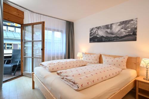 a bedroom with a bed with pillows on it at Ferienwohnung Nau in Oberstdorf