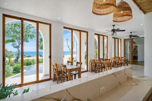 a dining room with a view of the ocean at HiDra Homestay in An Tịnh