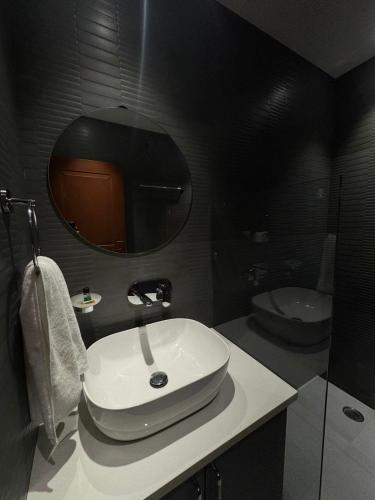 a bathroom with a white sink and a mirror at The Aero Lounge Hotel 2kms From Airport in Amritsar