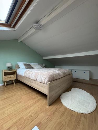 ein Schlafzimmer mit einem großen Bett und einem weißen Teppich in der Unterkunft Perfect cocoon for a romantic stay in La Celle-sous-Gouzon