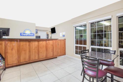 a dining room with a table and chairs and a tv at Days Inn by Wyndham Turlock in Turlock