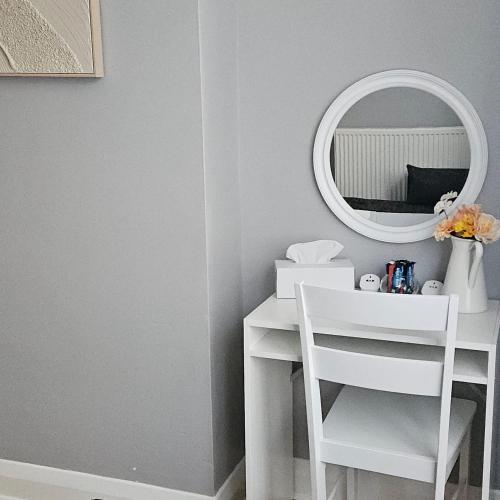 a white desk with a mirror and a white chair at Comfortable Private Rooms in Central London Next to Station in London