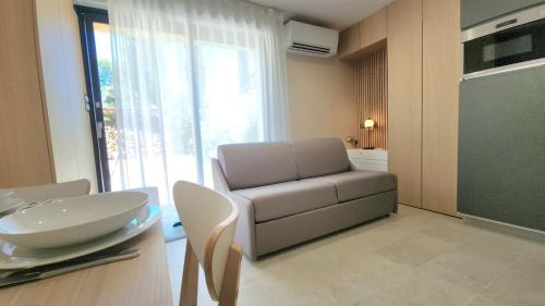 a living room with a couch and a table at Studio du Soleil in Le Val
