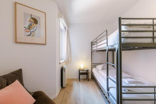 a living room with bunk beds and a couch at La Bohème Koksijde in Koksijde
