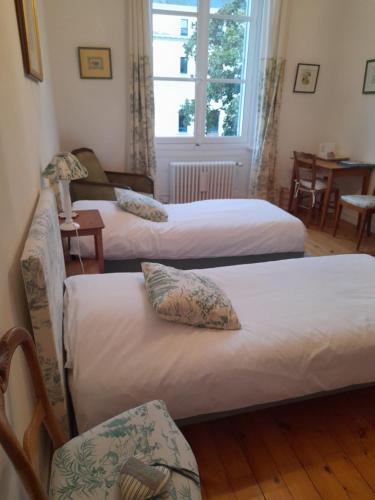 En eller flere senge i et værelse på Chambre d'Hôtes Marchand