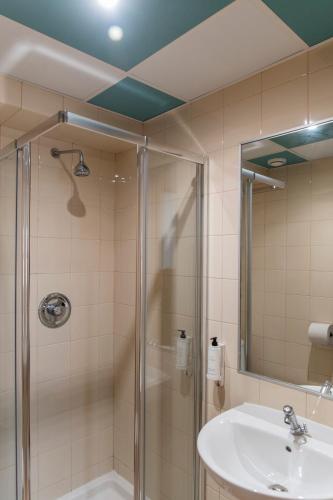 a bathroom with a shower and a sink at WOT Nomad Social in Lisbon