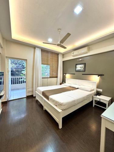a bedroom with a large bed and a window at The Ketan in Pune