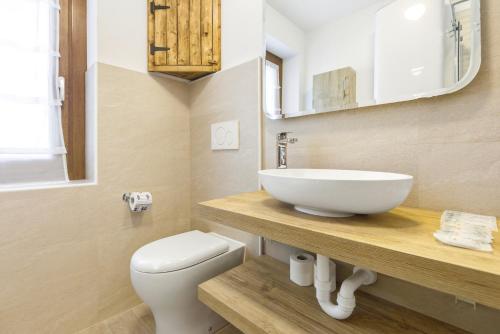 a bathroom with a sink and a toilet at Hostdomus - La Chapelle in Sauze d'Oulx