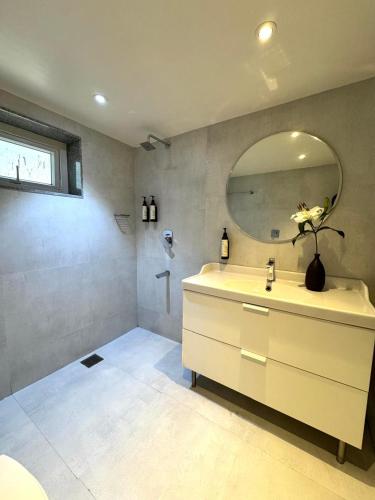 a bathroom with a sink and a mirror at The Ketan in Pune