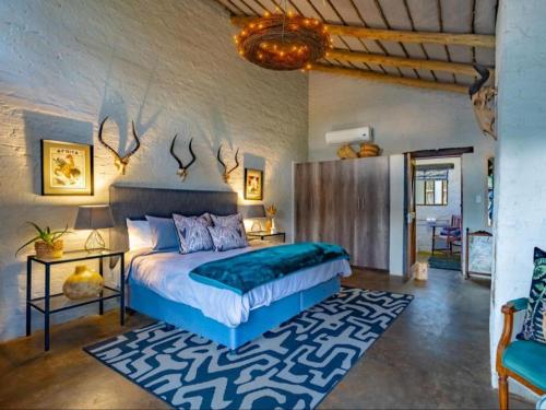 a bedroom with a bed in a room with a rug at Dombeya Private Game Reserve in Vaalwater