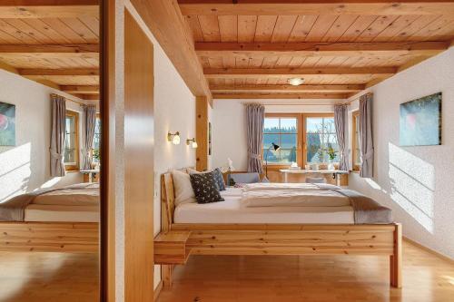 a bedroom with two beds and a window at Haldenmichelhof Ferienwohnungen in Breitnau