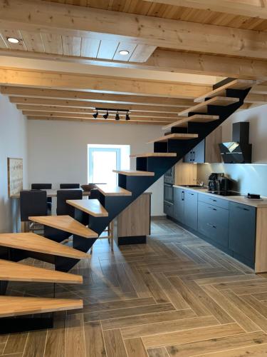 a spiral staircase in a kitchen with wooden floors at L'Ail des Ours in Les Estables