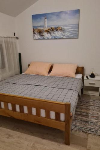 a bedroom with a bed with a lighthouse on the wall at Villa Kunta by Villas Guide in Gornja Jagodnja