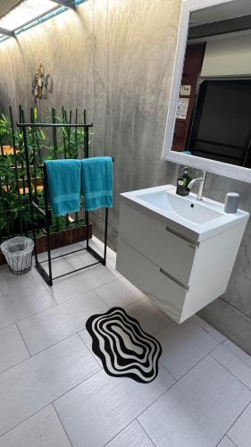 a bathroom with a sink and a mirror and a zebra rug at Sean Sabai The Secret Room in Ban Na We