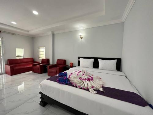 a bedroom with a large bed and a living room at Romny cozy bay Resort in Koh Rong Sanloem