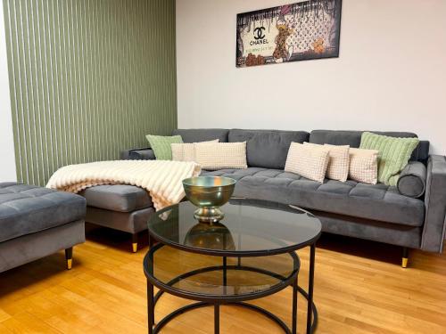 a living room with a couch and a table at Sylter Seestern App Ankerplatz in Morsum