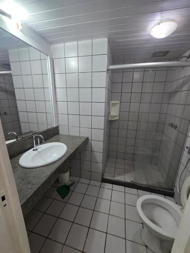 a bathroom with a sink and a toilet at Eco Paradise 129 in Caucaia