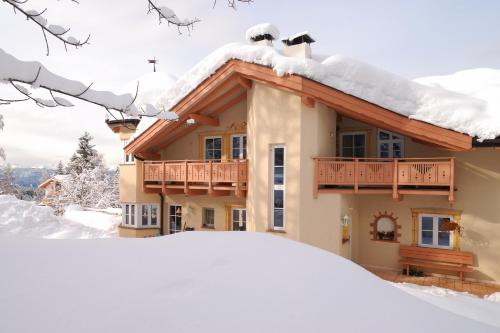 a house with snow on the roof at Ferienwohnung BERGKLANG in Nova Ponente