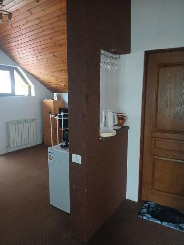 a room with a refrigerator and a wooden ceiling at Cărăbuș in Tuzla